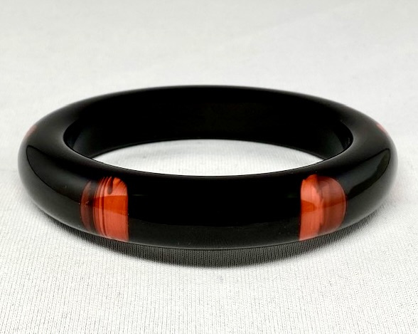 LG191 dark lucite bangle with 6 marbled orange dots 